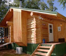 Log guest cabin with fireplace at Aikens Lake Wilderness Lodge