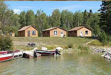 Sandy Point Camp guest cabins and fishing boats