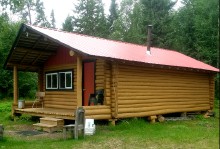 Log housekeeping cabin at Seven Lakes Wilderness Camps