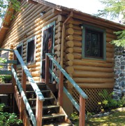 Quaint log guest cabin at Shady Roost Fishing Resort