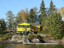 Waterfront cabin with boat dock at Spruce Island Camp