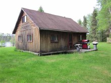 Guest log cabin on the lake at Swain Post Camp