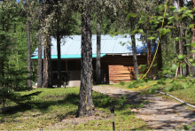 Guest cabin set in woods at Northern Reflection Lodge